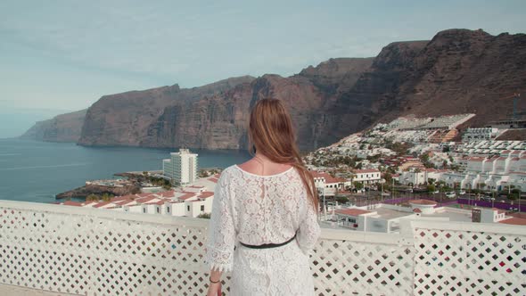 Woman Looks At Giant Cliffs Of Los Gigantes Tenerife