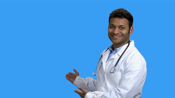 Smiling Doctor Showing Copy Space with Hands.