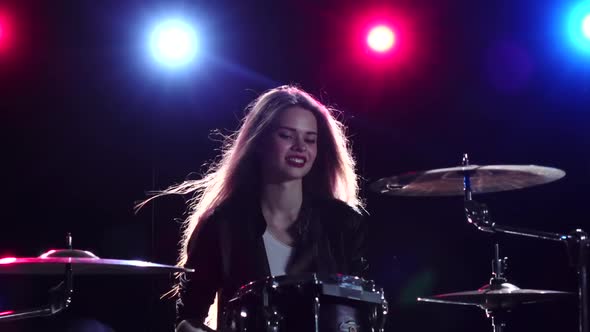 Girl Is Playing the Drums, Black Background, Red Blue Light From Behind, Slow Motion