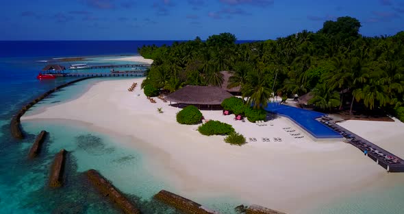 Beautiful birds eye travel shot of a white sandy paradise beach and aqua turquoise water background 