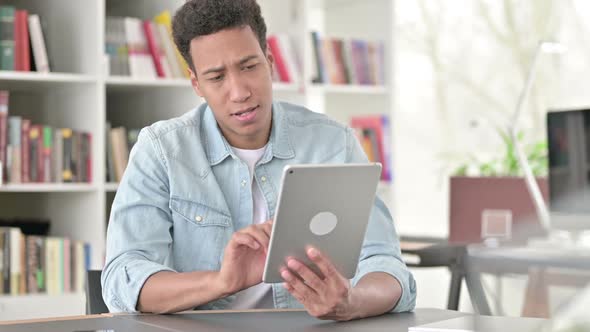 Creative Young African American Man Using Digital Tablet