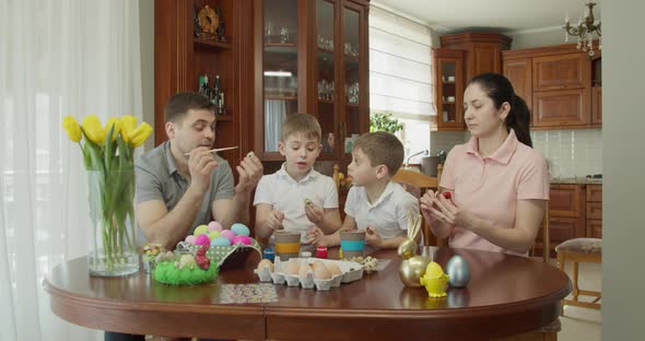 Easter Painting  Family with Two Boys Coloring Easter Eggs