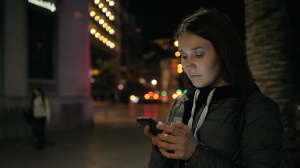 Woman Tourist Voice Recognition Ai Sending Audio Message on Cellphone Phone at Night City Street