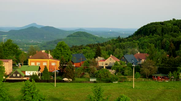 Countryside Village with Forests in Background - Sunny