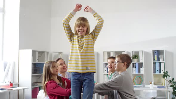 Teenager Falling Backwards and Others Catching during Trust Game