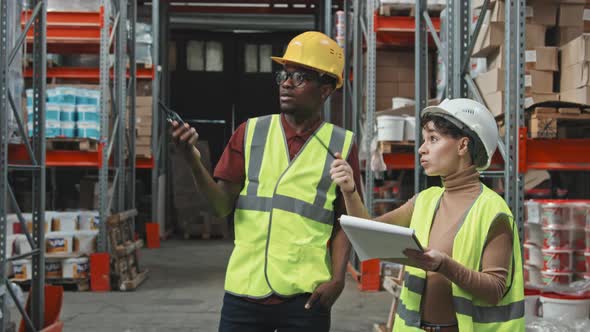 Female and Male Warehouse Workers in Workplace