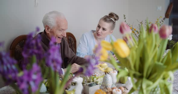 Happy Easter - Senior Man and Young Woman Conversating During Easter Holidays