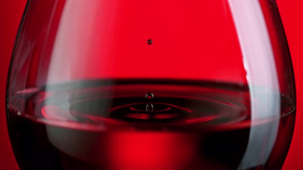 Super Slow Motion Shot of Wine Drop Falling Into Red Wine in Glass at 1000Fps