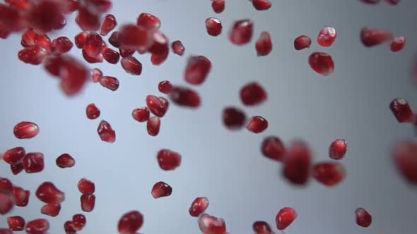 Pomegranate Grains Are Falling on White Background