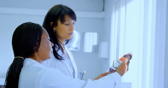 Laboratory technicians discussing over blood bag 4k