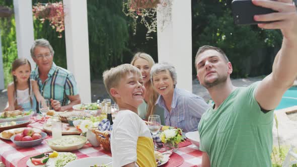 Happy family eating together at table