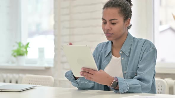 Young African Woman Using Tablet in Office