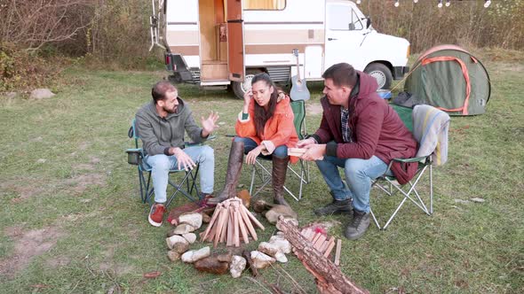 Caucasian Friend Around Camping Fire in the Mountains