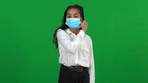 Happy African American Teenage Girl Taking Off Coronavirus Face Mask Looking at Camera Smiling
