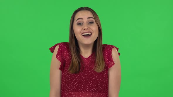 Portrait of Tender Girl in Red Dress Is Saying Wow with Shocked Facial Expression. Green Screen