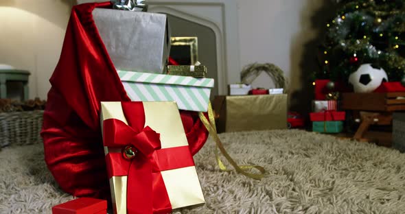 Close-up of sack and various gift boxes on rug