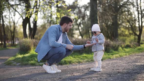 Adorable Little Gilr Spend Time with Her Father. Dad and Daughter Walk in the Park. Stylish Family