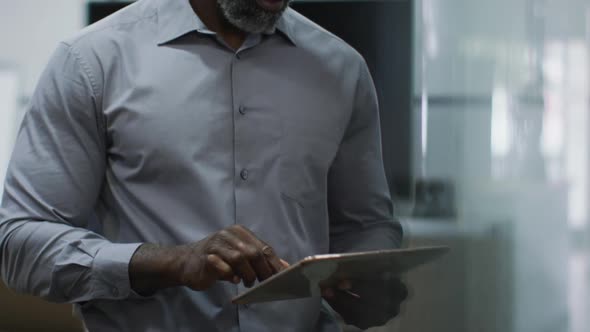 African american businessman using digital tablet in office