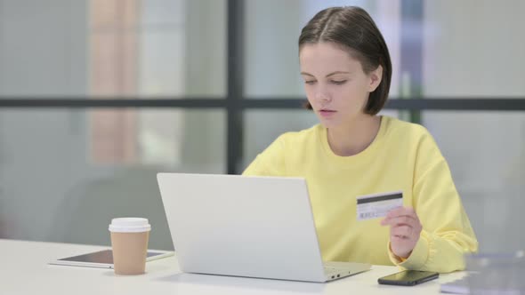 Young Woman Making Online Payment Failure on Laptop in Office