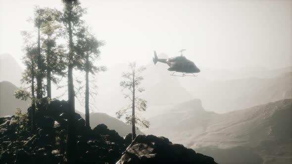 Extreme Slow Motion Flying Helicopter Near Mountain Forest