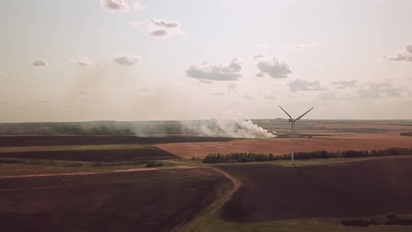 Wind Farms in the Field and a Burning Weald