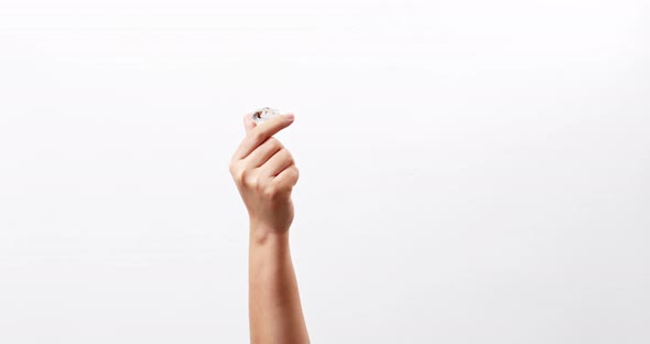 Large polished round cut diamond in hand close up isolated on a white studio background with copy sp