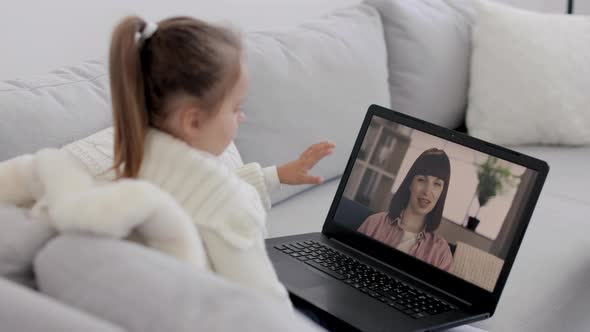 Happy Mother with Little Child Baby Girl Talking Through Video Call