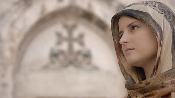 Woman in traditional clothes opens eyes