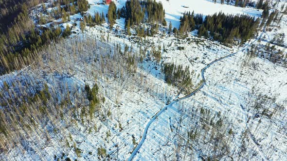 Snowy village near Tatry mountains. Aerial forward tilt-up reveal