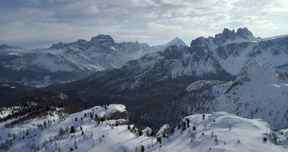 Forward Aerial to Snowy Alpine Valley with Woods Forest at Cinque Torri