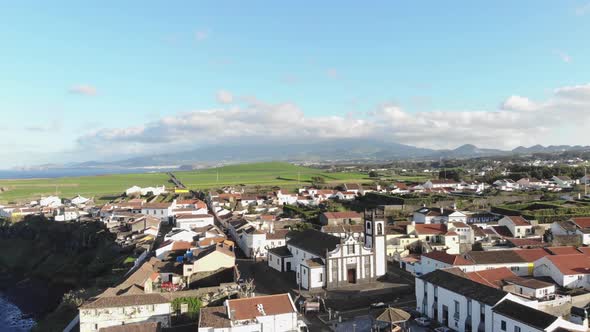 4k drone footage of a beautiful community overlooking the coast of Azores, Portugal.