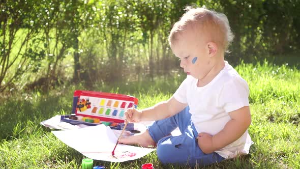 Toddler Boy Learns to Paint in Kindergarten