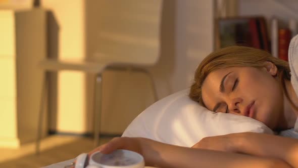 Sleepy Woman Waking Up and Looking at Alarm Clock, Getting Out of Bed in Hurry