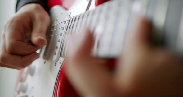 A Male Hand While Playing an Electro Acoustic Guitar