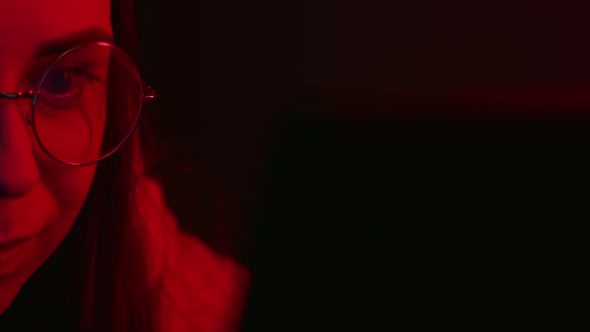 Young woman using laptop in studio In the night.