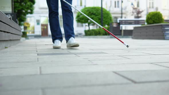 Young Blind Man with Using Safety Stick for Walking Alone Outdoors