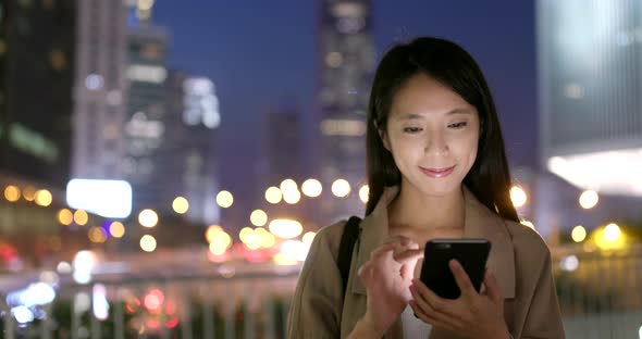 Woman use of smart phone at night