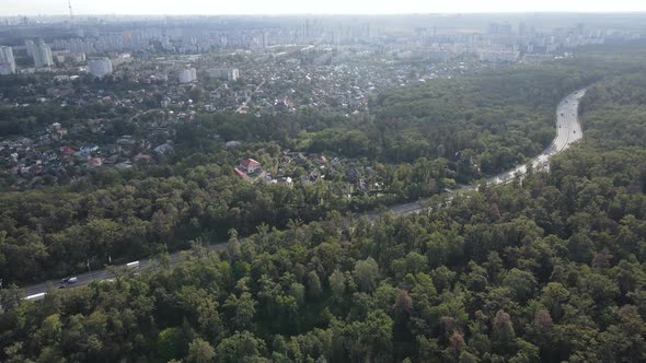 Megalopolis Next To the Forest: the Contact Between the Big City and Nature. Aerial View. Slow