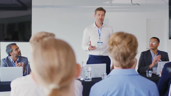 Speaker addressing the audience at a business conference