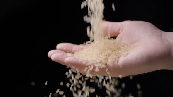 Rice falling in hand slow motion