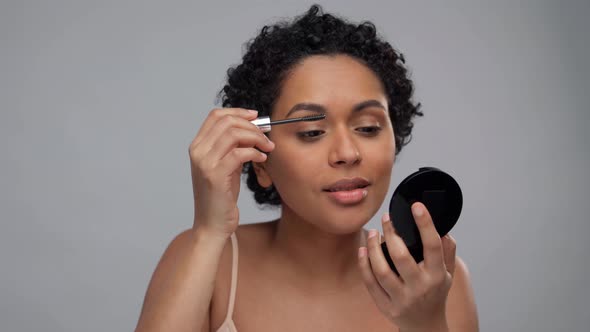 Beautiful African American Woman Applying Mascara