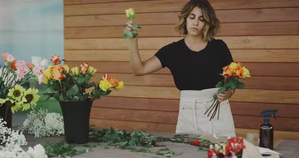 Florist picking flowers for bouquet