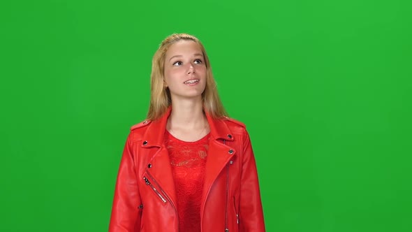 Portrait of Blonde Girl Calmly Walking on Green Screen Background. Chroma Key. Front View. Slow