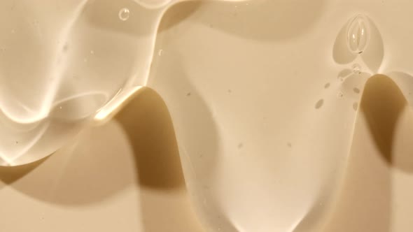 Beige Yellow Transparent Cosmetic Gel Fluid With Molecule Bubbles Flowing On The Plain Surface