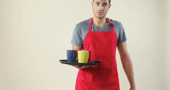 Smiling waiter holding a tray with coffee cups 4K 4k