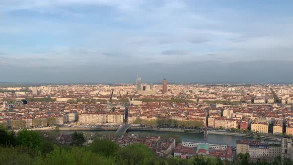 A very long panning view to the right of the entire city of Lyon, France as seen from the top of Bas