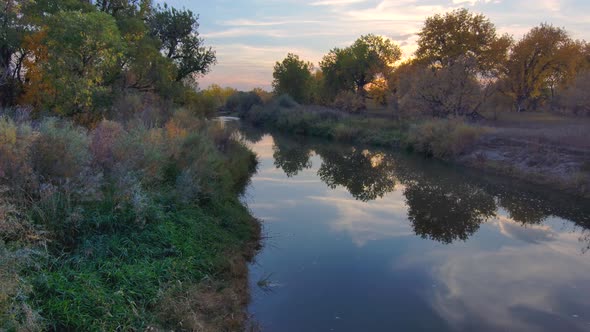 A kaleidoscope of fall colors in the sky, trees and river.  Autumn footage is the Platte river in No