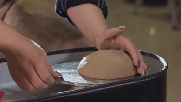 Pottery Crafting  Throwing a Piece of Clay on the Wheel and Forming It to the Center