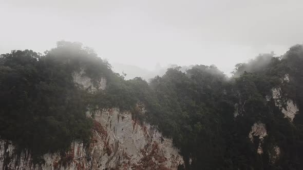 Panoramic View of a Foggy Ridge with Tropical Trees Clouds on a Rainy Day