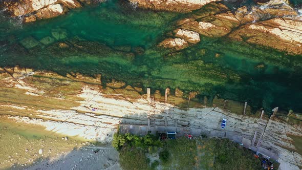 Top View of Rocky Coastline Down Blue Sea Deep White Cliffs